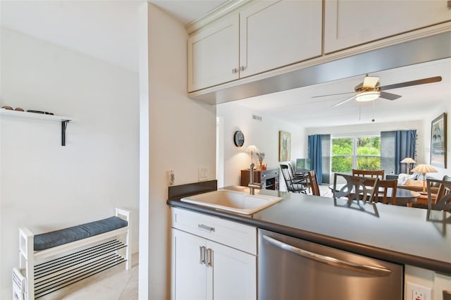 kitchen featuring white cabinets, light tile patterned floors, dishwasher, sink, and ceiling fan