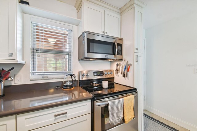 kitchen with appliances with stainless steel finishes and white cabinetry