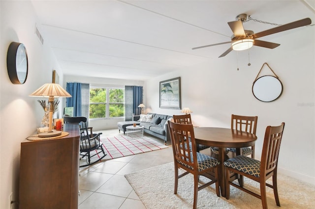 dining room featuring visible vents, ceiling fan, baseboards, and light tile patterned floors