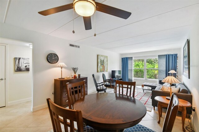 tiled dining room featuring ceiling fan