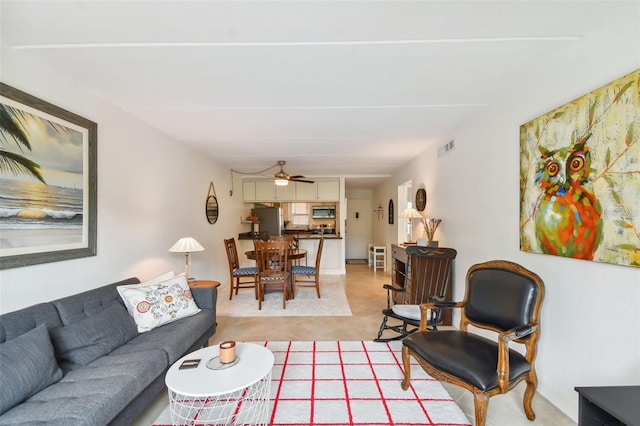 living room featuring ceiling fan and light tile patterned floors