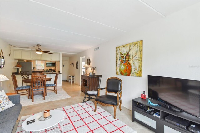 living room featuring light tile patterned floors and ceiling fan