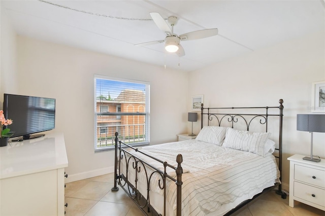 bedroom featuring light tile patterned flooring, ceiling fan, and baseboards