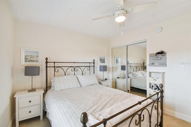 tiled bedroom featuring ceiling fan and a closet