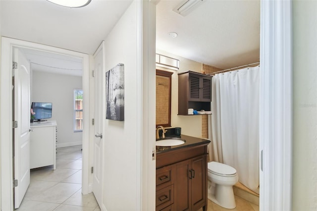 bathroom with toilet, tile patterned floors, vanity, a textured ceiling, and curtained shower