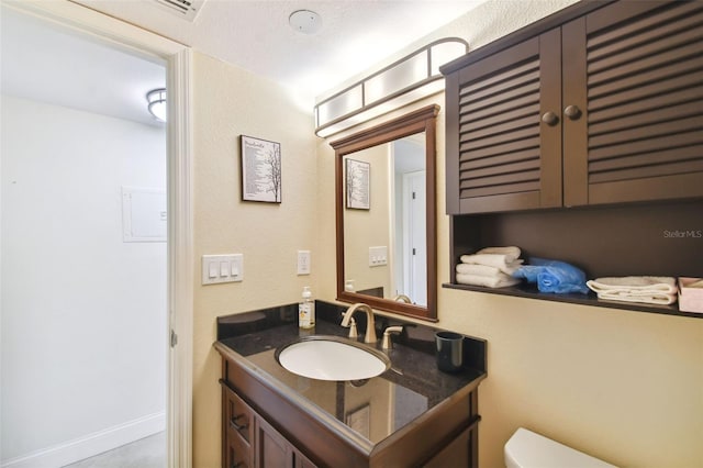 bathroom with toilet and vanity