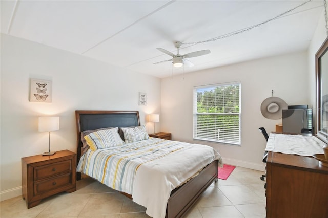 bedroom featuring light tile patterned floors, ceiling fan, and baseboards