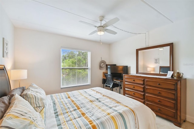 bedroom featuring light colored carpet and ceiling fan