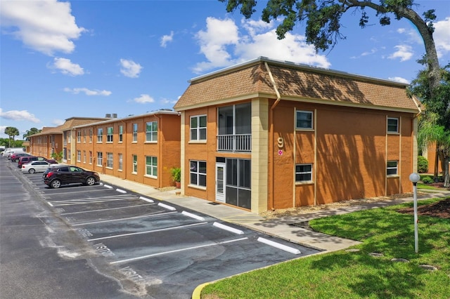 view of building exterior featuring uncovered parking