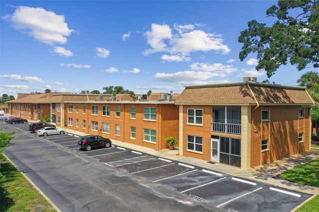 view of building exterior with uncovered parking