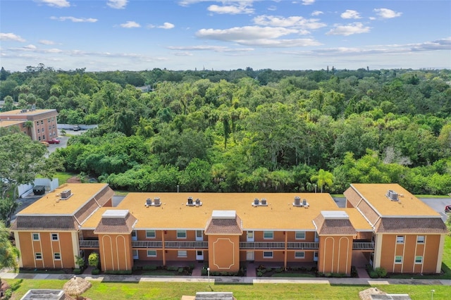 birds eye view of property featuring a view of trees