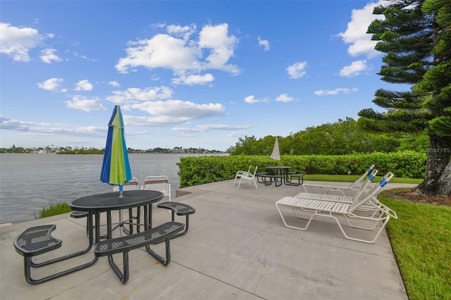 view of patio / terrace featuring a water view and outdoor dining area