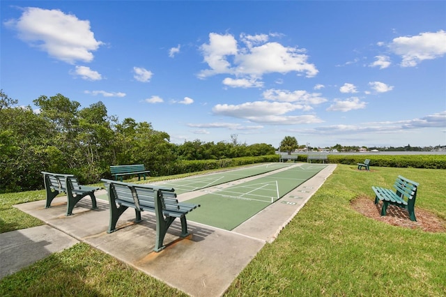 surrounding community featuring shuffleboard and a lawn