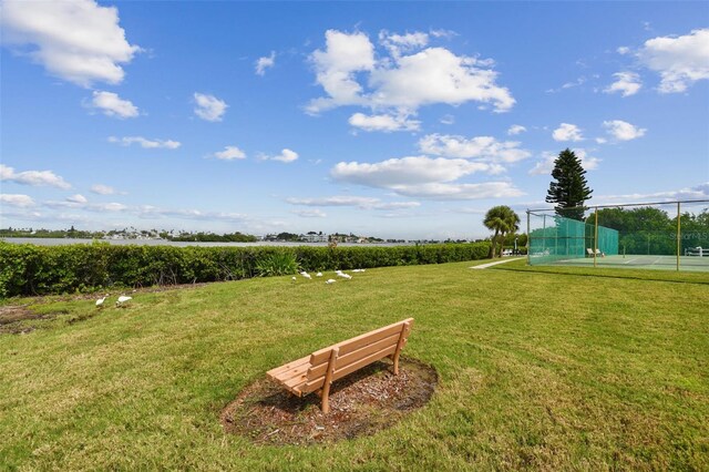 surrounding community featuring a yard, a rural view, and tennis court