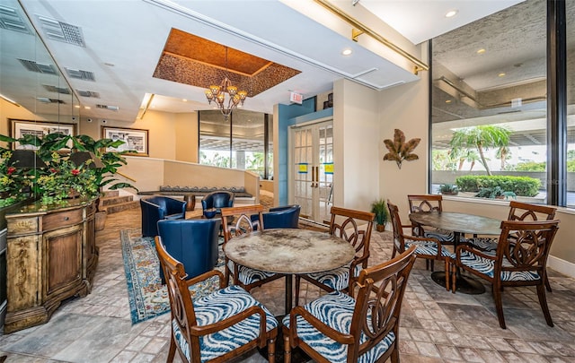 dining room with plenty of natural light and a notable chandelier