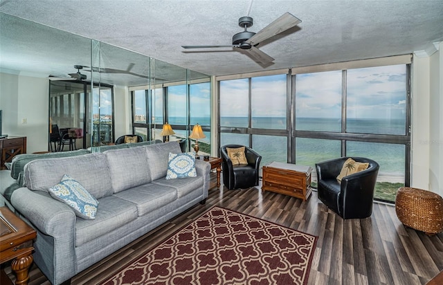 sunroom with a water view, ceiling fan, and plenty of natural light