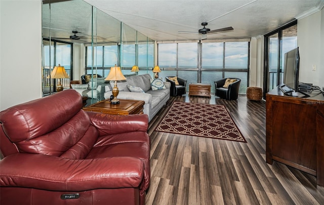 living room with a textured ceiling, dark wood-type flooring, ceiling fan, and a wall of windows