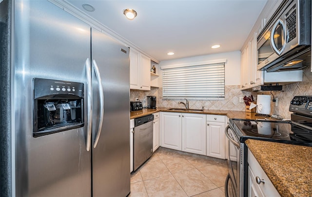 kitchen featuring white cabinetry, tasteful backsplash, stainless steel appliances, sink, and light tile patterned flooring