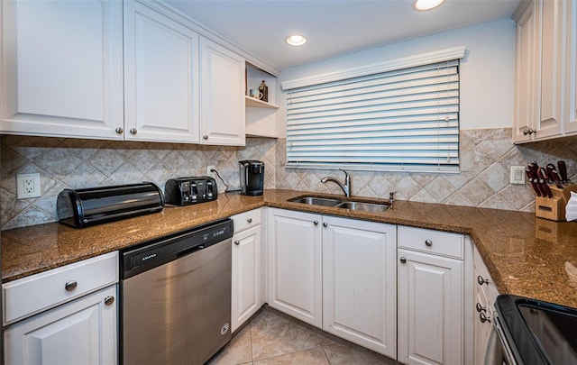 kitchen featuring appliances with stainless steel finishes, white cabinetry, and sink