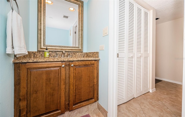 bathroom with tile patterned flooring and vanity