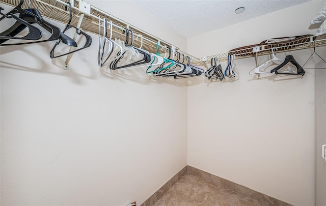 walk in closet with tile patterned flooring