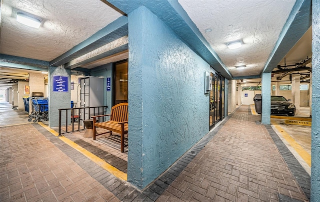 hallway with a textured ceiling