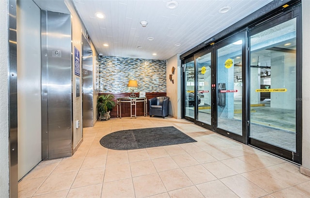 interior space featuring elevator and light tile patterned floors