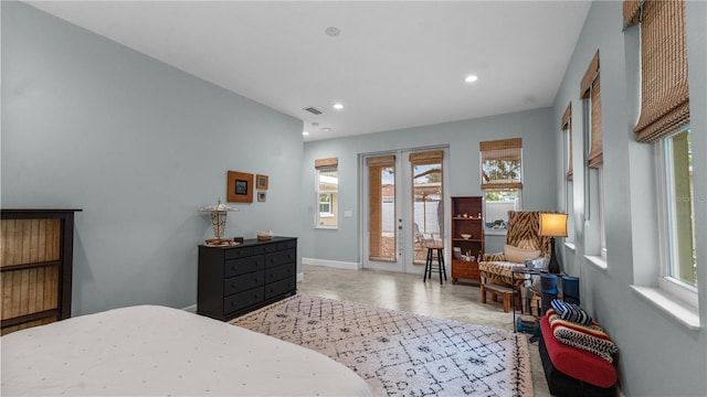 bedroom featuring multiple windows, french doors, and access to exterior