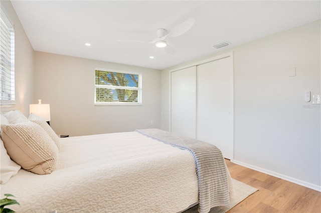 bedroom featuring a closet, ceiling fan, and light hardwood / wood-style flooring