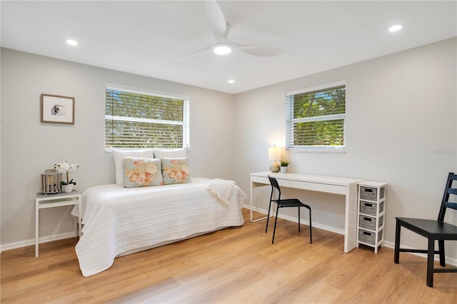 bedroom with light wood-type flooring, multiple windows, and ceiling fan