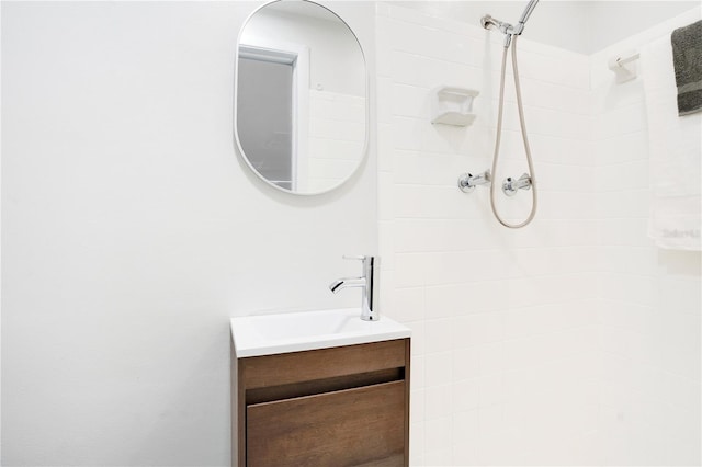 bathroom featuring vanity and tiled shower