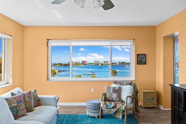 living area featuring beverage cooler, ceiling fan, and hardwood / wood-style flooring