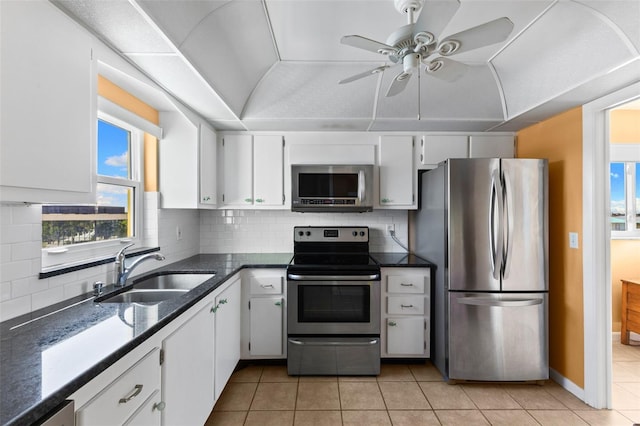 kitchen featuring sink, ceiling fan, decorative backsplash, appliances with stainless steel finishes, and white cabinets