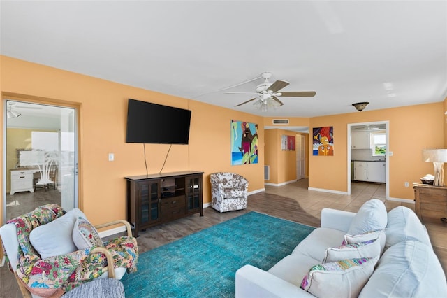 living room featuring hardwood / wood-style floors and ceiling fan