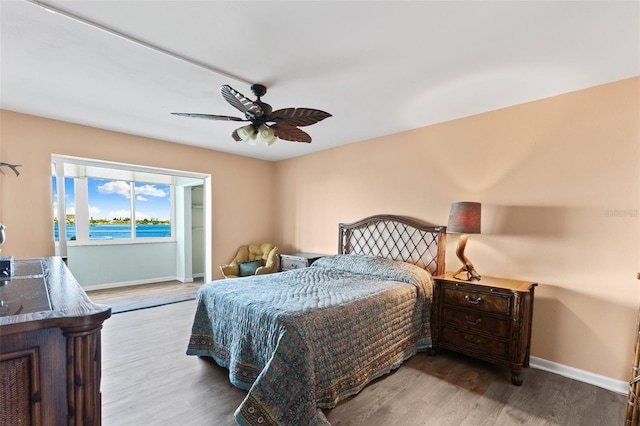 bedroom featuring wood-type flooring and ceiling fan