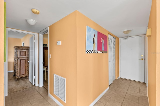 corridor featuring light tile patterned floors