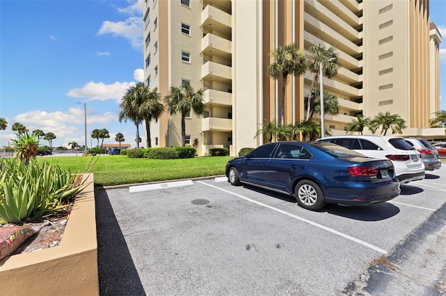 view of vehicle parking featuring a lawn