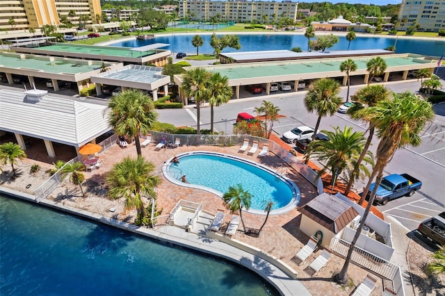 view of pool featuring a water view and a patio area