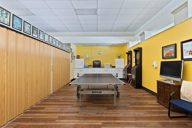 rec room featuring a paneled ceiling and dark hardwood / wood-style floors