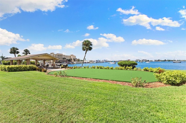 surrounding community with a gazebo, a yard, and a water view