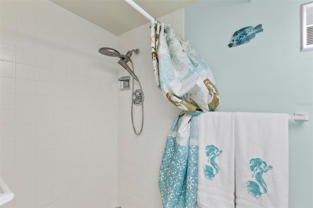 interior details featuring a tile shower