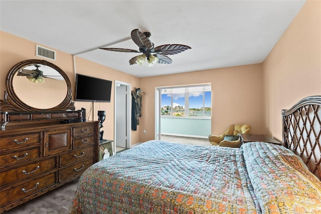 bedroom with dark wood-style floors, visible vents, and ceiling fan