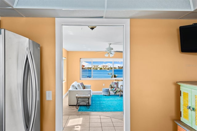 interior space with tile patterned floors and a ceiling fan