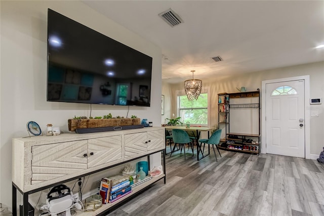 interior space featuring hardwood / wood-style flooring and an inviting chandelier