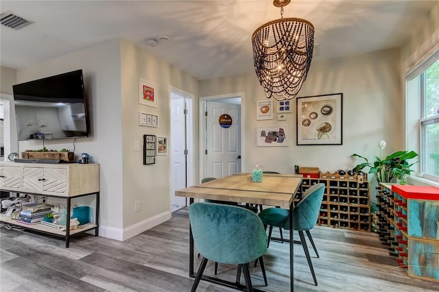 dining area featuring a notable chandelier and hardwood / wood-style flooring