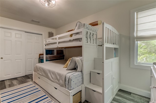 bedroom with a closet and hardwood / wood-style flooring