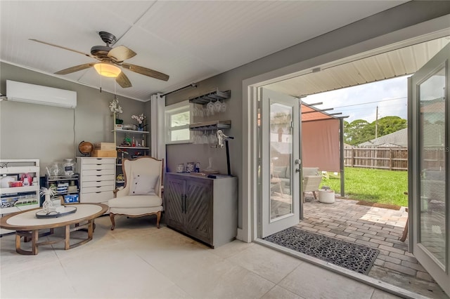 interior space with ceiling fan and an AC wall unit