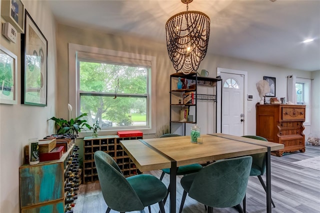 dining room with wood-type flooring and a chandelier