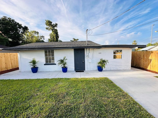 ranch-style house featuring a patio area and a front yard