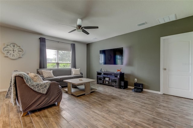 living room featuring light hardwood / wood-style flooring and ceiling fan